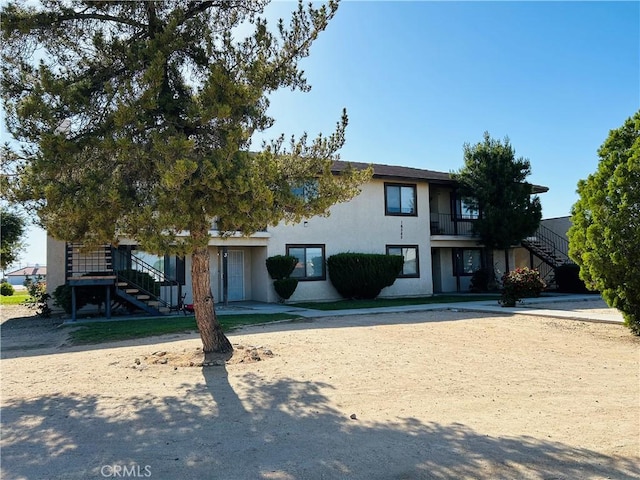 16585 Green Tree Blvd, Victorville, CA 92395 - view of front of home featuring stairway and stucco siding