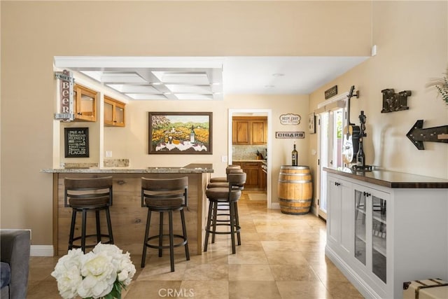 6021 Saddletree Ln, Yorba Linda, CA 92886 - indoor wet bar with coffered ceiling, light tile patterned flooring, beamed ceiling, and backsplash