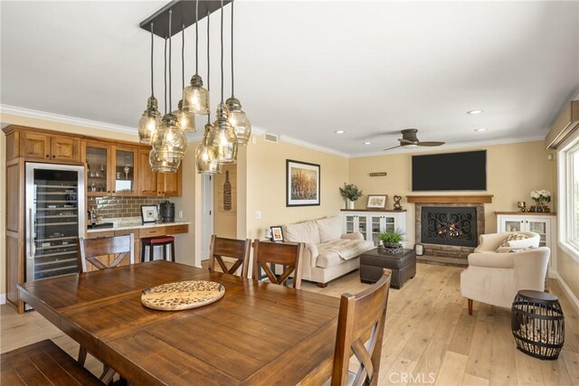 6021 Saddletree Ln, Yorba Linda, CA 92886 - dining area with beverage cooler, light wood-type flooring, recessed lighting, crown molding, and ceiling fan