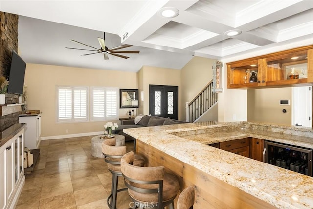 6021 Saddletree Ln, Yorba Linda, CA 92886 - kitchen with wine cooler, coffered ceiling, beam ceiling, ceiling fan, and light stone counters