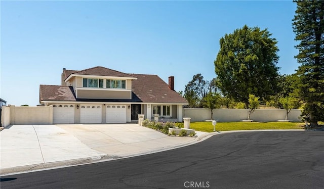 6021 Saddletree Ln, Yorba Linda, CA 92886 - view of front of property featuring a chimney, an attached garage, and driveway