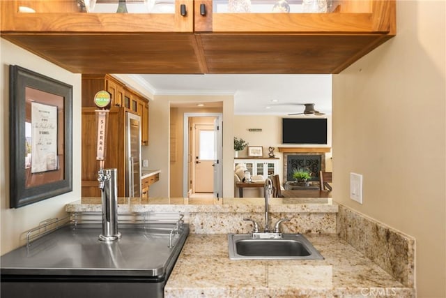 6021 Saddletree Ln, Yorba Linda, CA 92886 - kitchen featuring crown molding, a ceiling fan, and light stone counters