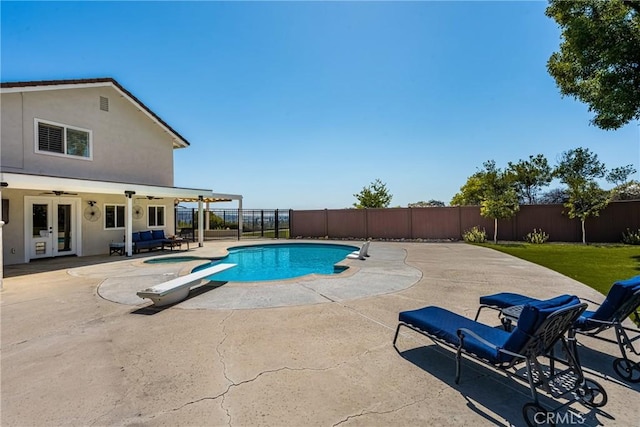 6021 Saddletree Ln, Yorba Linda, CA 92886 - view of swimming pool with french doors, a fenced backyard, a diving board, and a ceiling fan