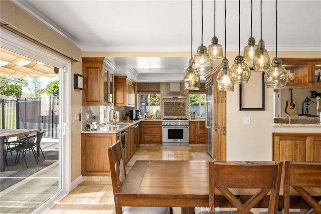 6021 Saddletree Ln, Yorba Linda, CA 92886 - kitchen with high quality appliances, wall chimney exhaust hood, brown cabinets, glass insert cabinets, and decorative backsplash