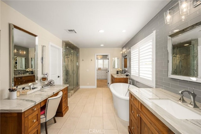 6021 Saddletree Ln, Yorba Linda, CA 92886 - bathroom featuring a stall shower, two vanities, a freestanding tub, tile patterned floors, and recessed lighting