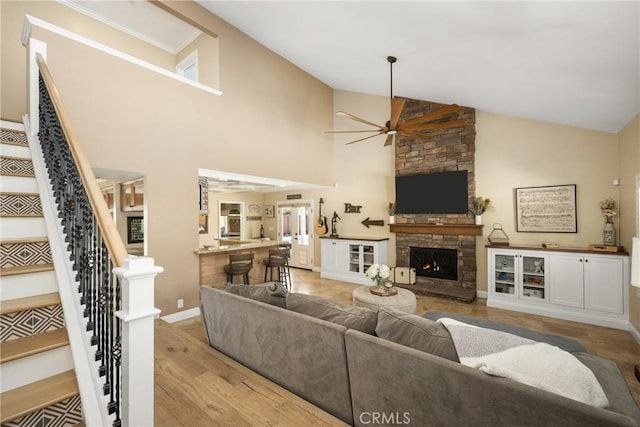6021 Saddletree Ln, Yorba Linda, CA 92886 - living area featuring a ceiling fan, high vaulted ceiling, a fireplace, stairs, and light wood finished floors