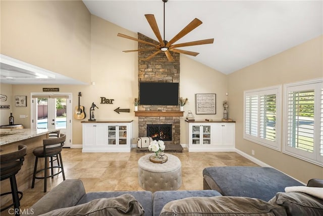 6021 Saddletree Ln, Yorba Linda, CA 92886 - living area featuring a ceiling fan, high vaulted ceiling, healthy amount of natural light, a stone fireplace, and light tile patterned floors