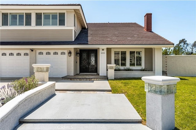 6021 Saddletree Ln, Yorba Linda, CA 92886 - view of front of property featuring a chimney, a front lawn, and a garage