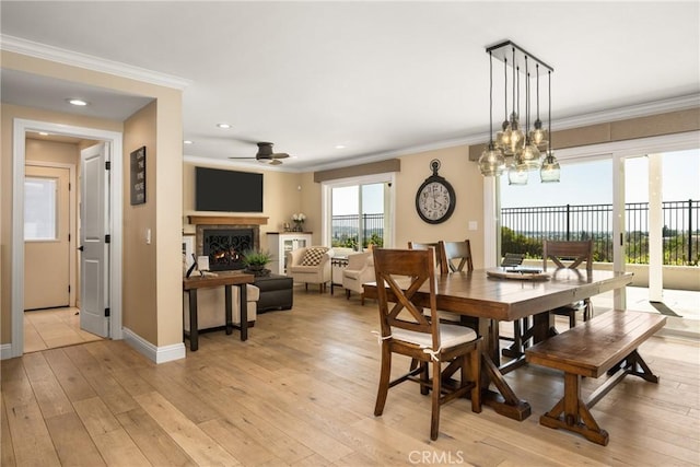 6021 Saddletree Ln, Yorba Linda, CA 92886 - dining area with a warm lit fireplace, light wood-type flooring, crown molding, recessed lighting, and a ceiling fan