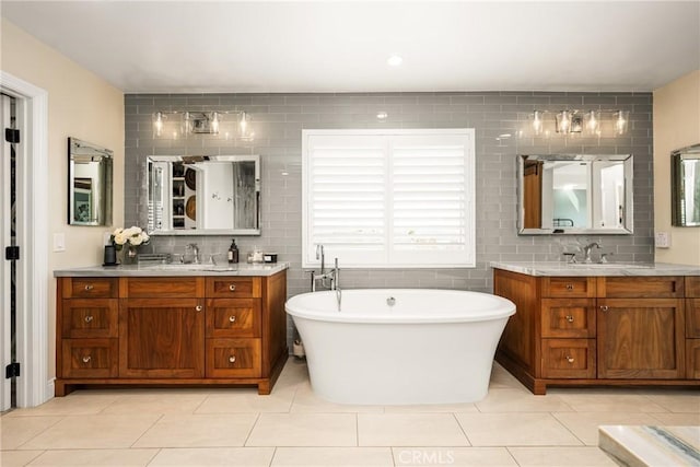 6021 Saddletree Ln, Yorba Linda, CA 92886 - full bath with two vanities, a freestanding bath, tile patterned flooring, tasteful backsplash, and tile walls