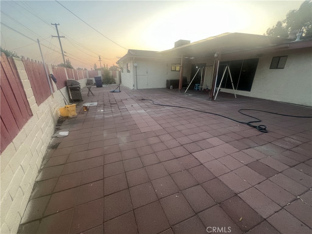 3401 Purdue Dr, Bakersfield, CA 93306 - patio terrace at dusk featuring a patio and area for grilling
