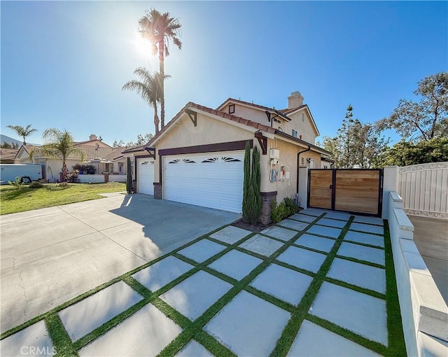 795 Donatello Dr, Corona, CA 92882 - view of front of home featuring a chimney, stucco siding, a gate, an attached garage, and concrete driveway