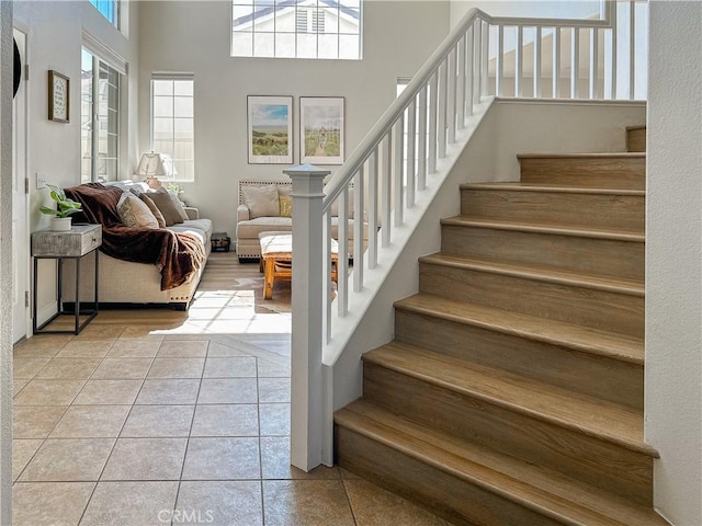 795 Donatello Dr, Corona, CA 92882 - stairs featuring tile patterned floors and a towering ceiling