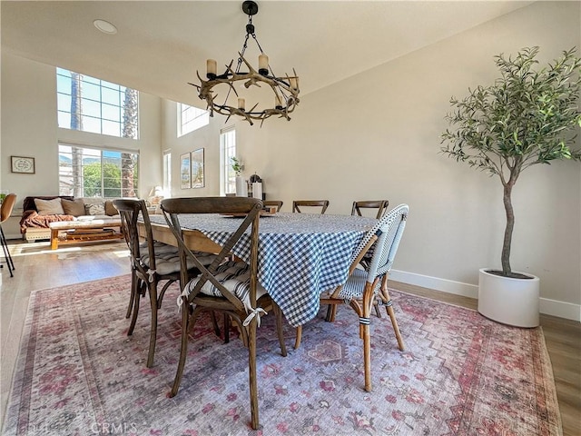 795 Donatello Dr, Corona, CA 92882 - dining area featuring a chandelier, wood finished floors, and a high ceiling