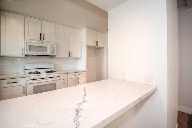 26769 Cherry Hills Blvd, Menifee, CA 92586 - kitchen with white appliances, backsplash, light stone counters, white cabinets, and baseboards