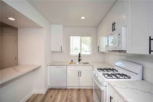 26769 Cherry Hills Blvd, Menifee, CA 92586 - kitchen with white appliances, a sink, light wood-style floors, decorative backsplash, and white cabinetry