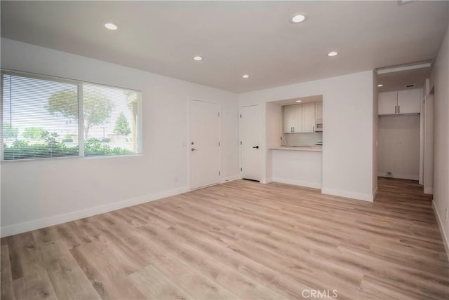 26769 Cherry Hills Blvd, Menifee, CA 92586 - unfurnished living room featuring light wood-style floors, recessed lighting, and baseboards