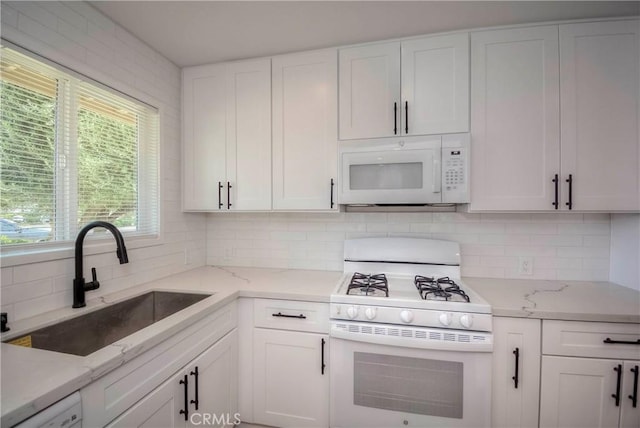 26769 Cherry Hills Blvd, Menifee, CA 92586 - kitchen with white appliances, a sink, tasteful backsplash, white cabinets, and light stone counters