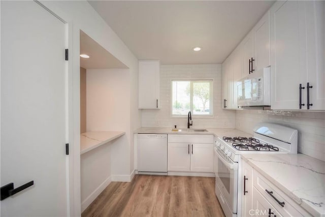 26769 Cherry Hills Blvd, Menifee, CA 92586 - kitchen with white appliances, a sink, light wood-style flooring, tasteful backsplash, and white cabinets