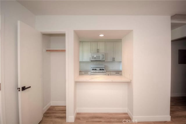 26769 Cherry Hills Blvd, Menifee, CA 92586 - kitchen featuring white appliances, light wood-style floors, light countertops, and baseboards