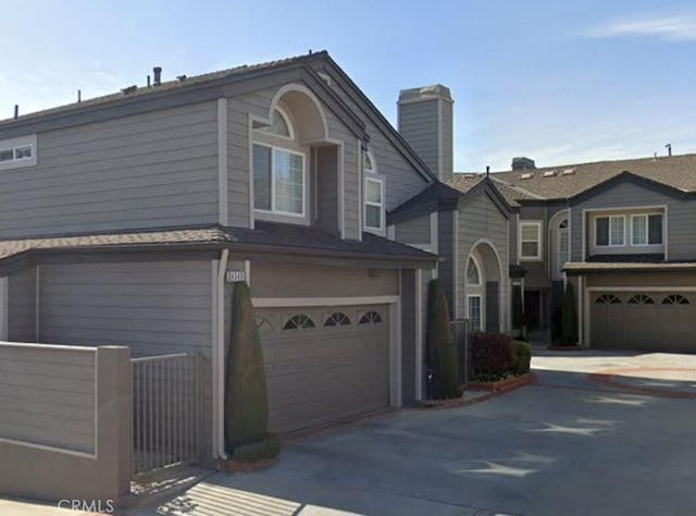 24545 Santa Clara Ave, Dana Point, CA 92629 - townhome / multi-family property with an attached garage, driveway, and a chimney