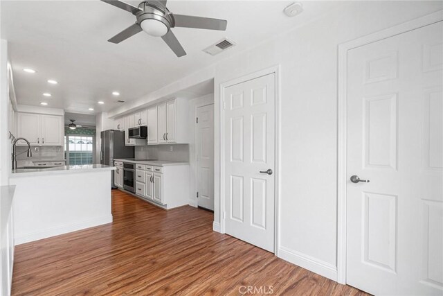 24545 Santa Clara Ave, Dana Point, CA 92629 - kitchen featuring ceiling fan, appliances with stainless steel finishes, white cabinets, dark wood-style floors, and light countertops
