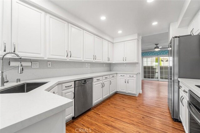 24545 Santa Clara Ave, Dana Point, CA 92629 - kitchen with stainless steel appliances, a ceiling fan, light wood-type flooring, white cabinetry, and light countertops