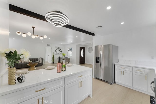 17121 Simonds St, Granada Hills, CA 91344 - kitchen with stainless steel fridge, white cabinets, recessed lighting, light wood-style floors, and light stone counters