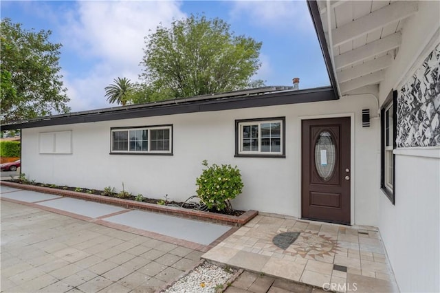 17121 Simonds St, Granada Hills, CA 91344 - view of exterior entry featuring stucco siding and a patio