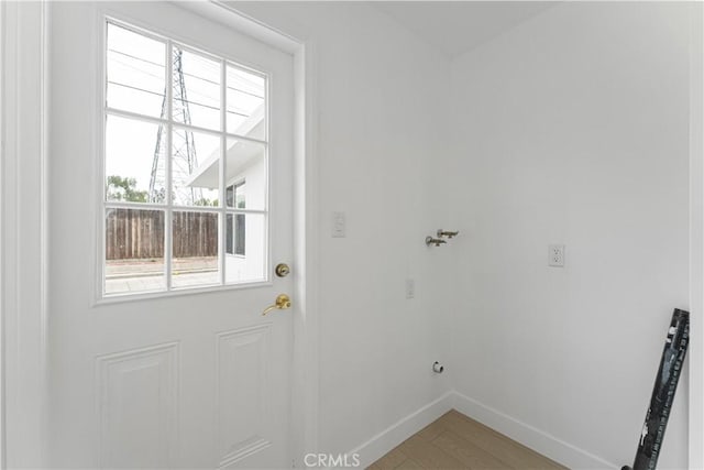 17121 Simonds St, Granada Hills, CA 91344 - doorway featuring baseboards and light wood-style flooring