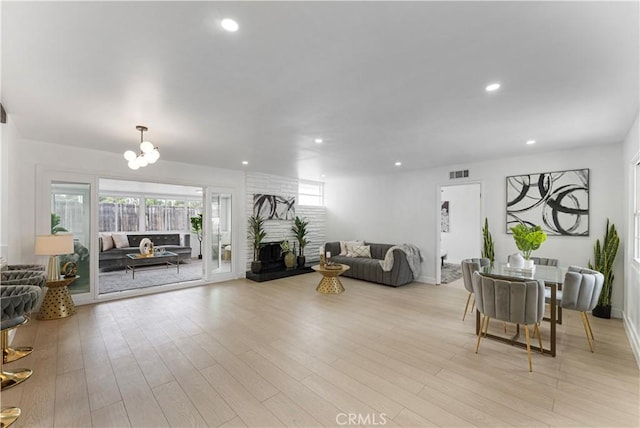 17121 Simonds St, Granada Hills, CA 91344 - living area featuring recessed lighting, light wood-style floors, a brick fireplace, a chandelier, and baseboards