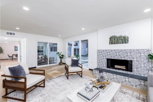 12009 Dresden Pl, Granada Hills, CA 91344 - living area featuring a fireplace with raised hearth, light wood finished floors, and recessed lighting
