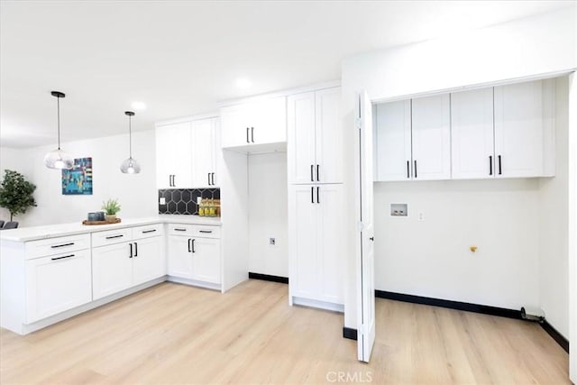 12009 Dresden Pl, Granada Hills, CA 91344 - kitchen with light wood-style flooring, a peninsula, white cabinets, light countertops, and recessed lighting