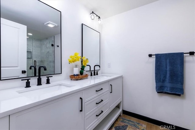 12009 Dresden Pl, Granada Hills, CA 91344 - full bath featuring double vanity, a shower stall, wood finished floors, and baseboards