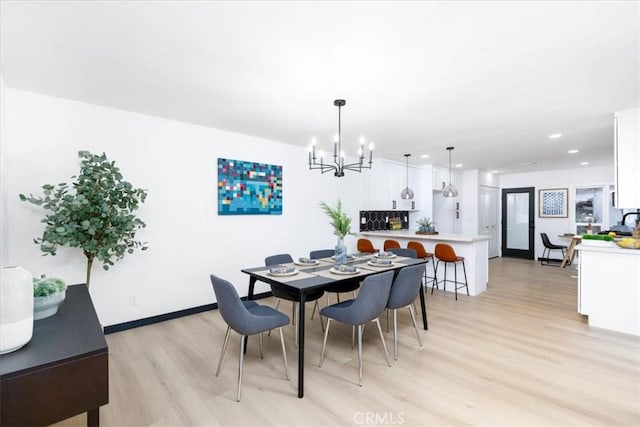 12009 Dresden Pl, Granada Hills, CA 91344 - dining room with a chandelier, light wood-style flooring, recessed lighting, and baseboards
