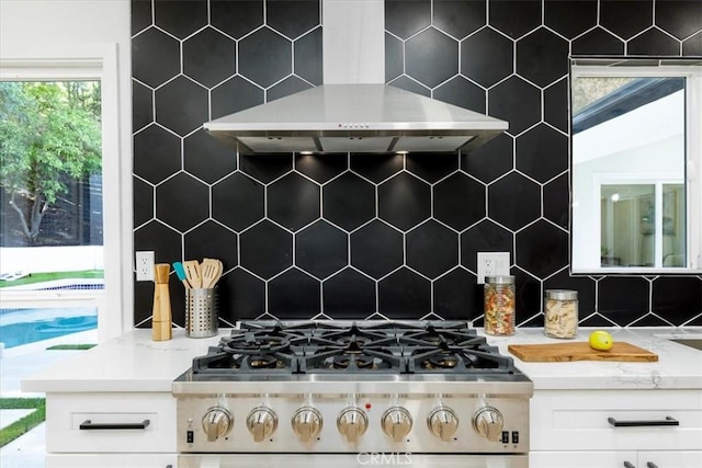12009 Dresden Pl, Granada Hills, CA 91344 - kitchen featuring wall chimney exhaust hood, tasteful backsplash, white cabinetry, and cooktop