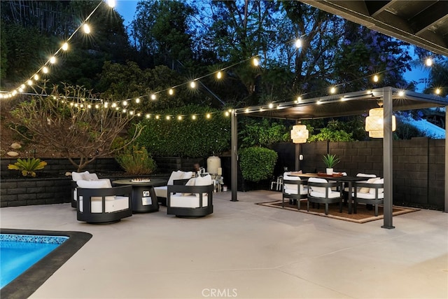 19851 Malaga Ln, Yorba Linda, CA 92886 - patio at twilight with an outdoor fire pit, a patio area, outdoor dining space, and a fenced backyard