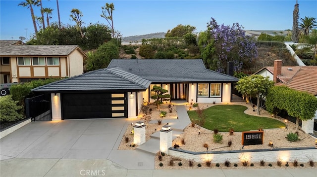 19851 Malaga Ln, Yorba Linda, CA 92886 - tudor home featuring an attached garage, a front lawn, and driveway