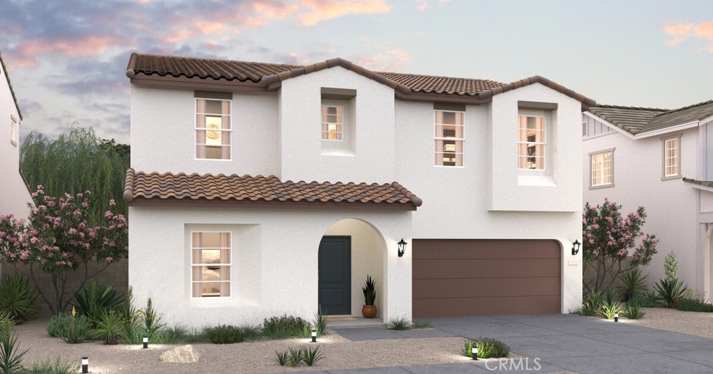 3377 Poplar St, Rosamond, CA 93560 - mediterranean / spanish home featuring an attached garage, concrete driveway, and a tile roof