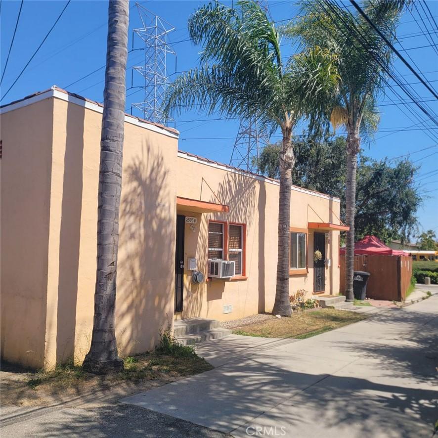 8995 Victoria Ave, South Gate, CA 90280 - view of side of property with stucco siding and cooling unit