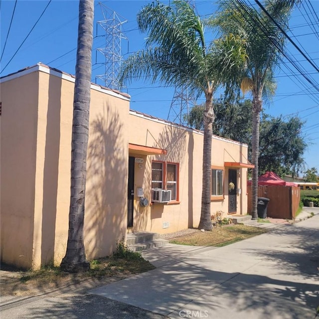 8995 Victoria Ave, South Gate, CA 90280 - view of side of property with stucco siding and cooling unit