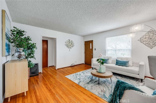 1206 W 187th Pl, Gardena, CA 90248 - living area with a textured ceiling and light wood-type flooring