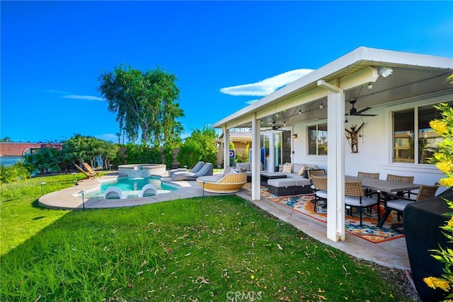 84290 Tramonto Way, Indio, CA 92203 - view of green lawn with a ceiling fan, a patio, an outdoor living space, and a pool with connected hot tub
