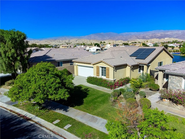 84290 Tramonto Way, Indio, CA 92203 - view of front of property with an attached garage, stucco siding, a tiled roof, and a mountain view
