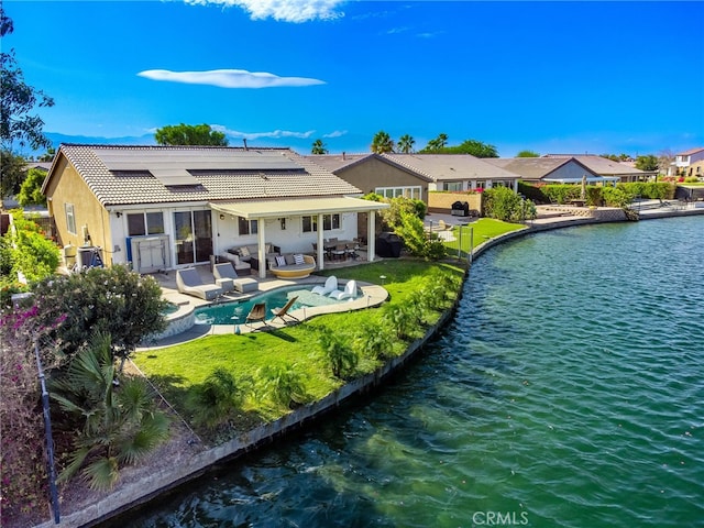 84290 Tramonto Way, Indio, CA 92203 - rear view of property featuring an outdoor hangout area, roof mounted solar panels, a tiled roof, a patio area, and an outdoor pool