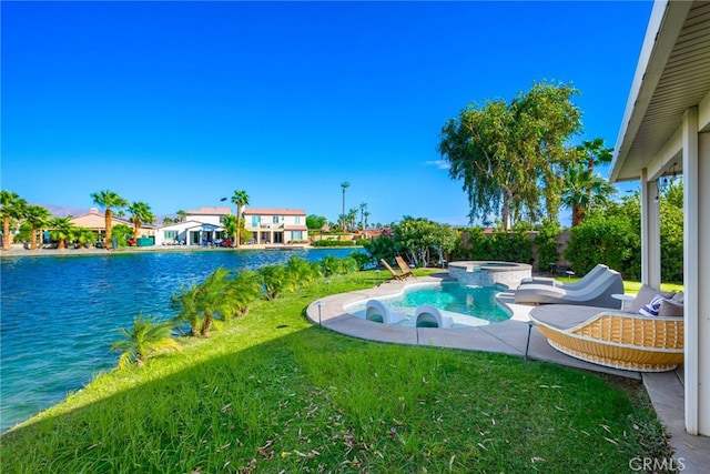 84290 Tramonto Way, Indio, CA 92203 - view of swimming pool featuring a lawn, a pool with connected hot tub, and a water view
