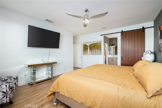 84290 Tramonto Way, Indio, CA 92203 - bedroom featuring wood finished floors, baseboards, a barn door, and ceiling fan