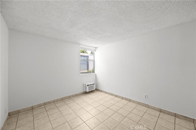 18620 Hatteras St Unit 274, Tarzana, CA 91356 - spare room featuring a textured ceiling, a wall mounted air conditioner, and light tile patterned floors