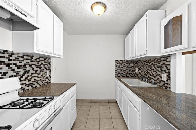 18620 Hatteras St Unit 274, Tarzana, CA 91356 - kitchen featuring a sink, white gas range oven, exhaust hood, dark countertops, and a textured ceiling