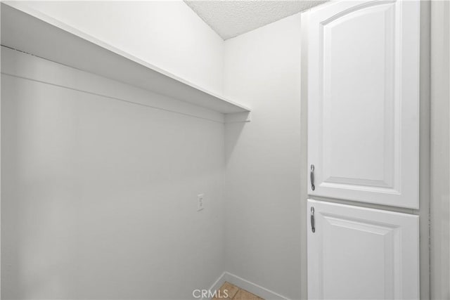 18620 Hatteras St Unit 274, Tarzana, CA 91356 - laundry area with a textured ceiling